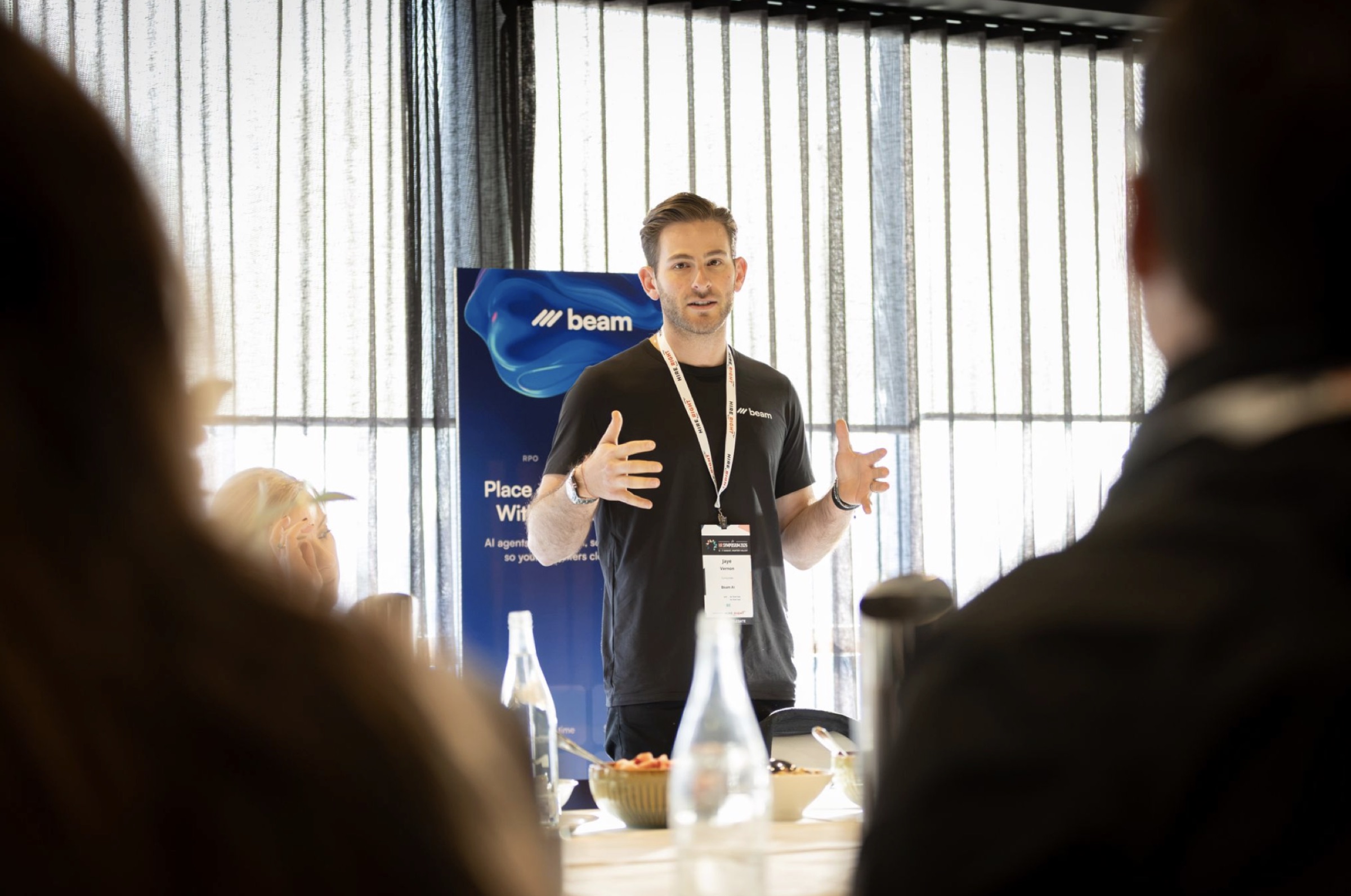 Beam AI speaking at a recruitment symposium